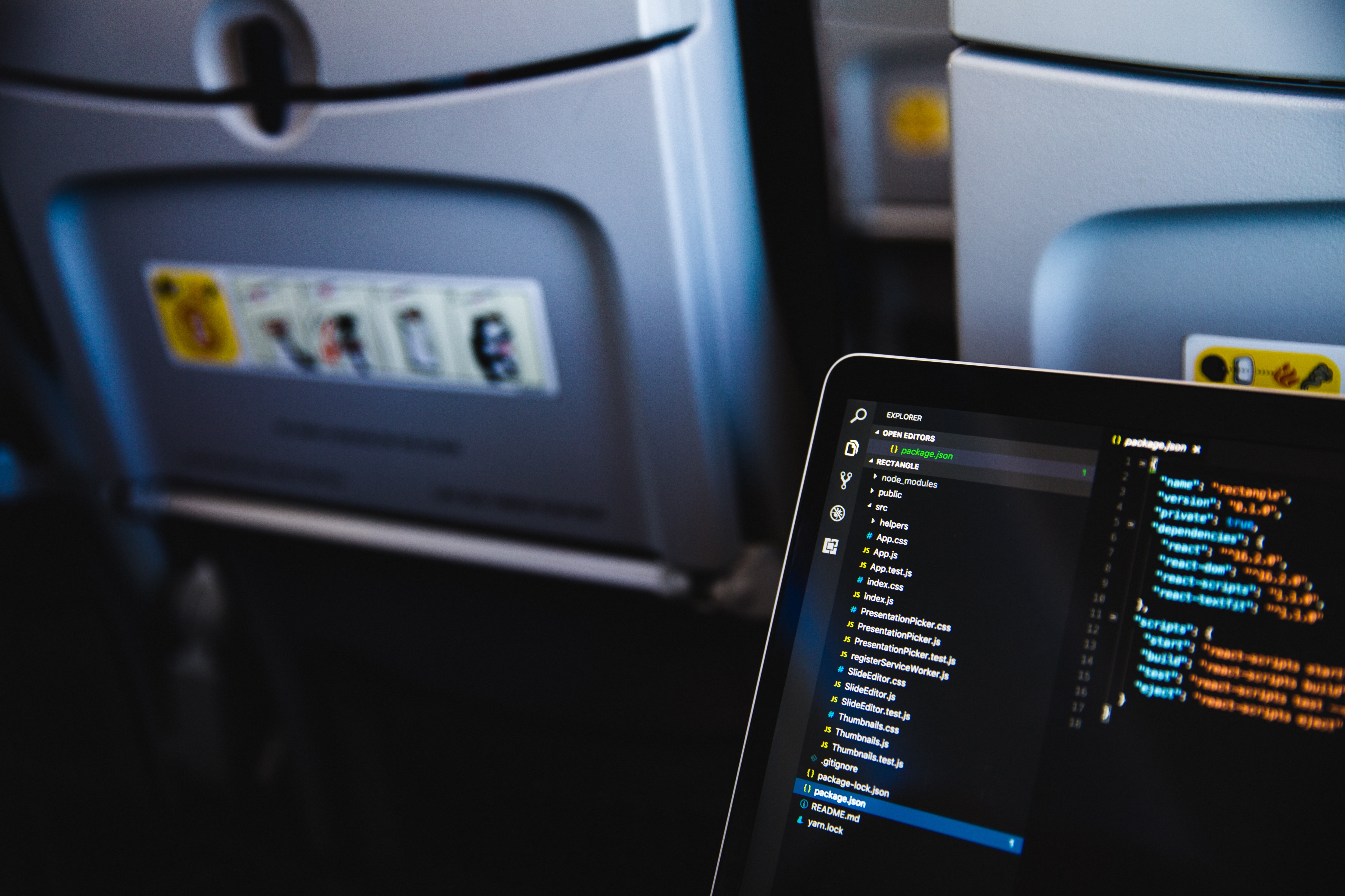 Computer open with code on the screen in an airplane